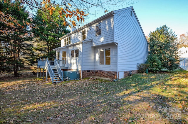 view of side of property featuring a yard and a deck