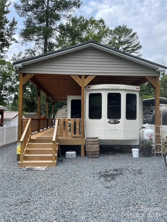 view of front of home with a shed and a deck