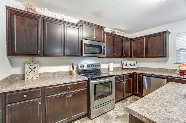 kitchen with dark brown cabinetry and appliances with stainless steel finishes