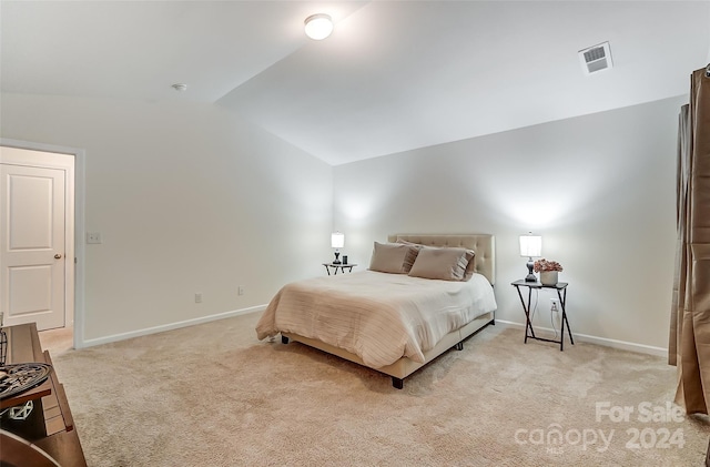 carpeted bedroom featuring vaulted ceiling