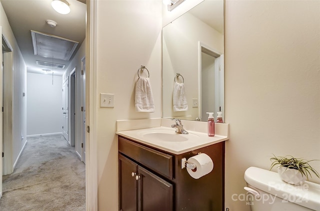 bathroom featuring vanity and toilet