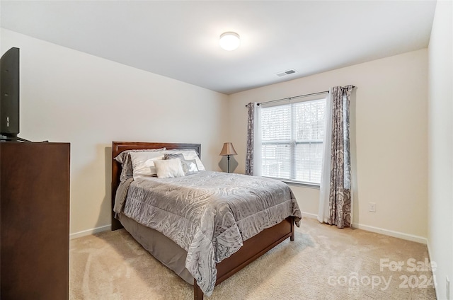 bedroom featuring light colored carpet