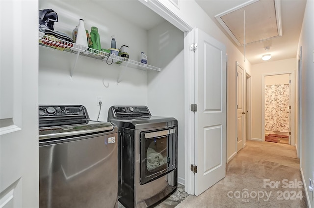 laundry area featuring washer and dryer and light carpet