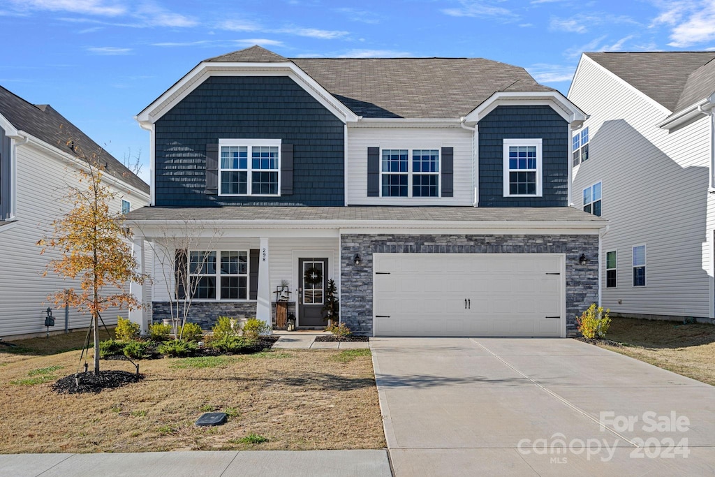 view of front of house featuring a garage and a front lawn