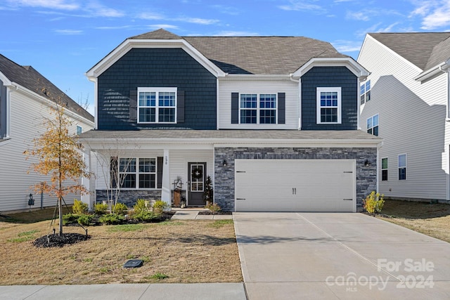 view of front of house featuring a garage and a front lawn