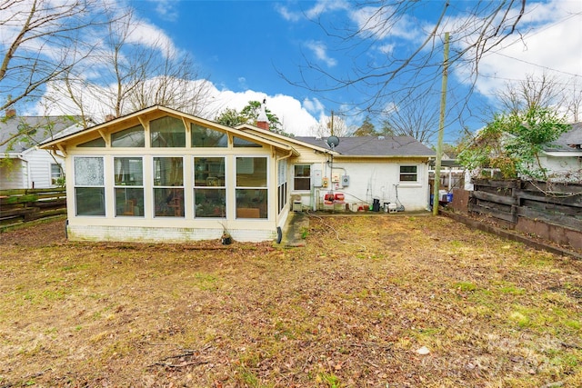 back of house featuring a sunroom