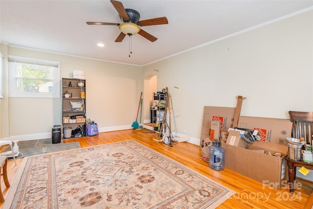 miscellaneous room with ceiling fan, wood-type flooring, and ornamental molding