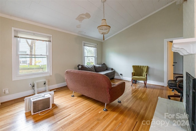 living room featuring a fireplace, wood-type flooring, vaulted ceiling, and ornamental molding