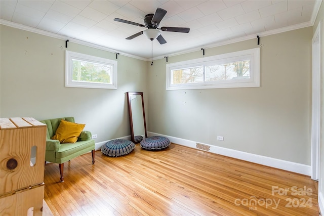 sitting room featuring crown molding, ceiling fan, and hardwood / wood-style flooring