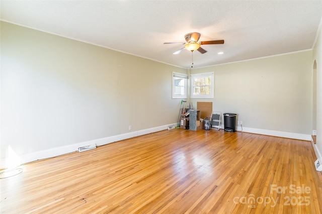 spare room with a textured ceiling, ornamental molding, light hardwood / wood-style floors, and ceiling fan