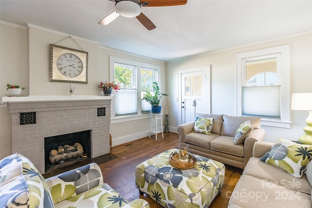 living room featuring ceiling fan, a fireplace, dark wood-type flooring, and ornamental molding