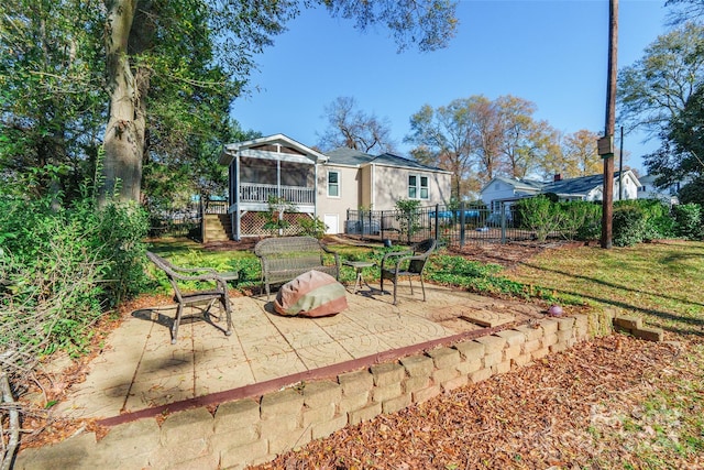 rear view of property featuring a patio area and a sunroom