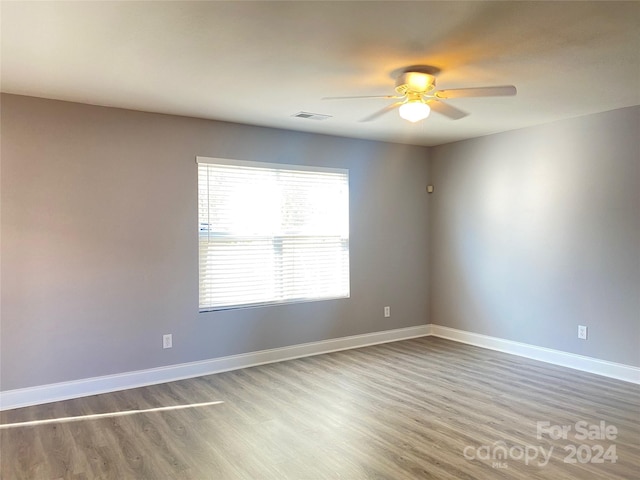 unfurnished room with hardwood / wood-style floors and ceiling fan