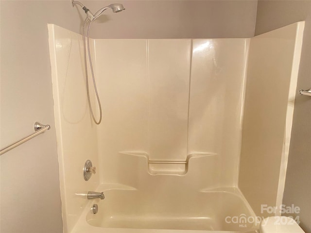 bathroom featuring toilet and tub / shower combination