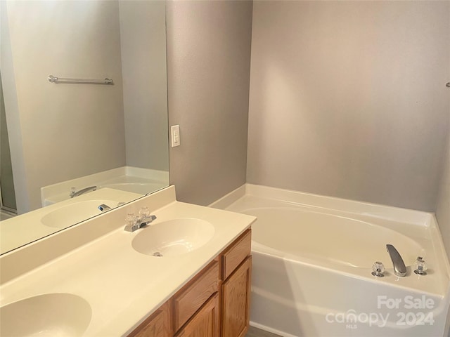 bathroom with a bath and vanity