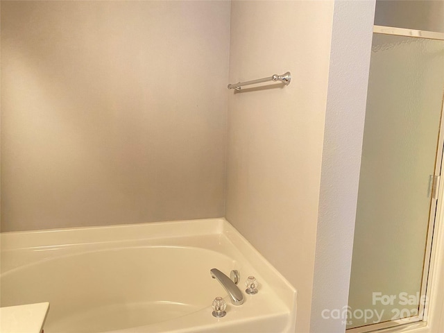 bathroom with a bathing tub and vanity