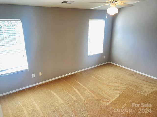 empty room featuring carpet flooring and ceiling fan