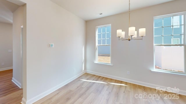 9601 Pointer Rd Unit 77, Huntersville, NC 28078 - unfurnished dining area with a chandelier and light hardwood / wood-style flooring