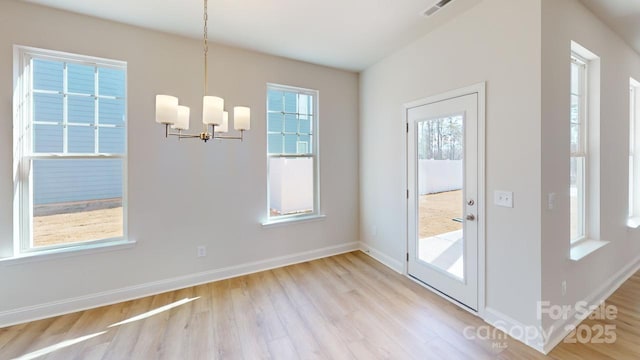 9601 Pointer Rd Unit 77, Huntersville, NC 28078 - unfurnished dining area with a notable chandelier and light hardwood / wood-style floors