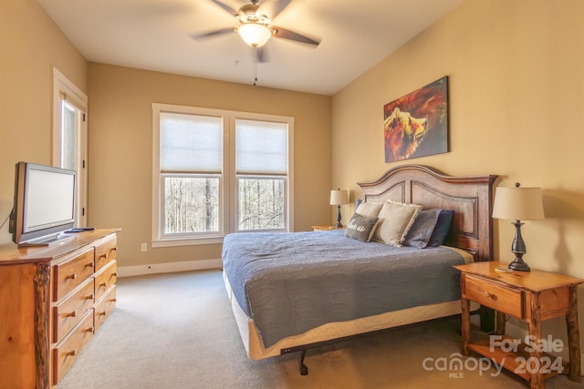 bedroom with light colored carpet and ceiling fan