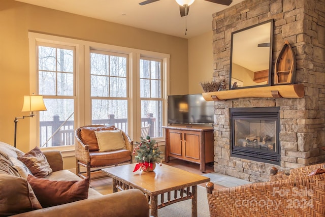 living room featuring ceiling fan, a fireplace, and a wealth of natural light