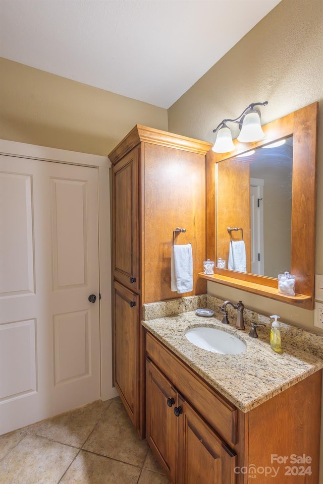 bathroom with tile patterned flooring and vanity