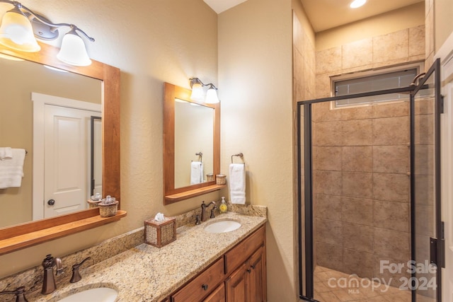 bathroom featuring vanity and an enclosed shower