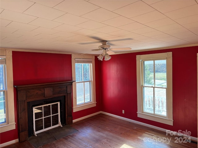 unfurnished living room featuring ceiling fan, crown molding, and wood-type flooring