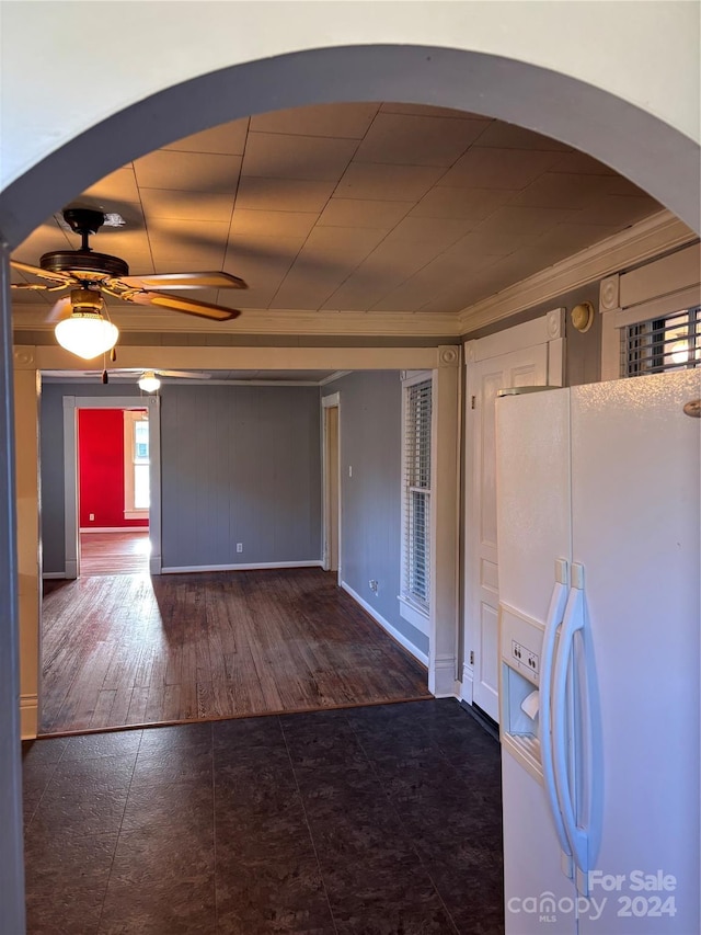 kitchen with crown molding, white fridge with ice dispenser, dark wood-type flooring, and ceiling fan