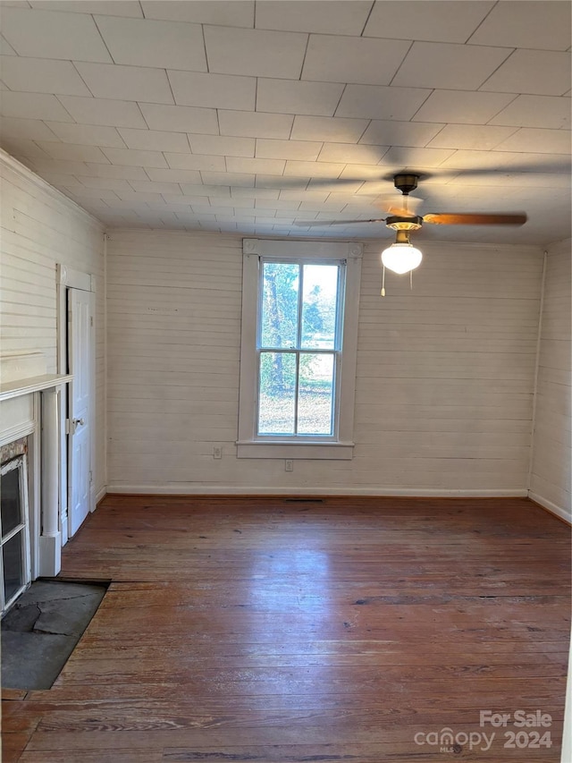 unfurnished living room with dark wood-type flooring