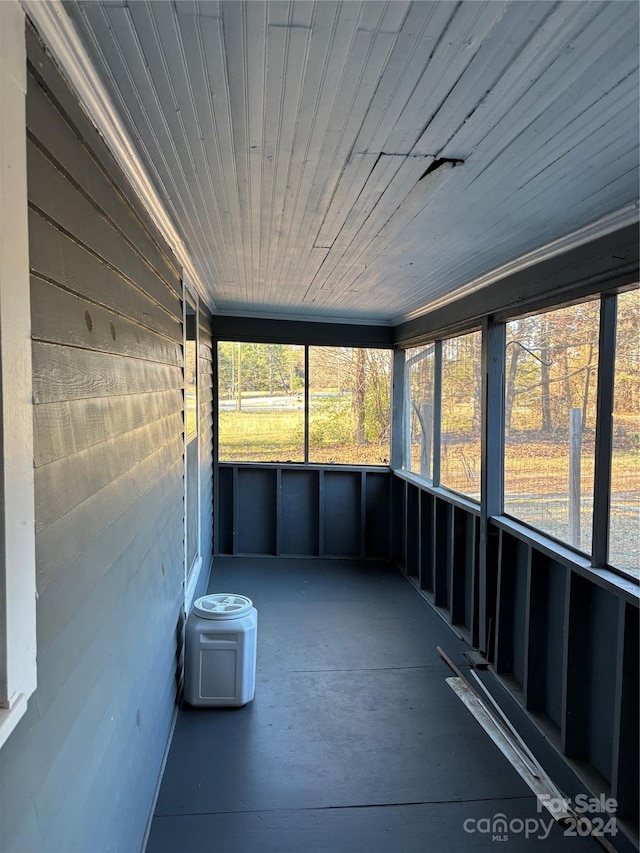 unfurnished sunroom with a wealth of natural light and wood ceiling