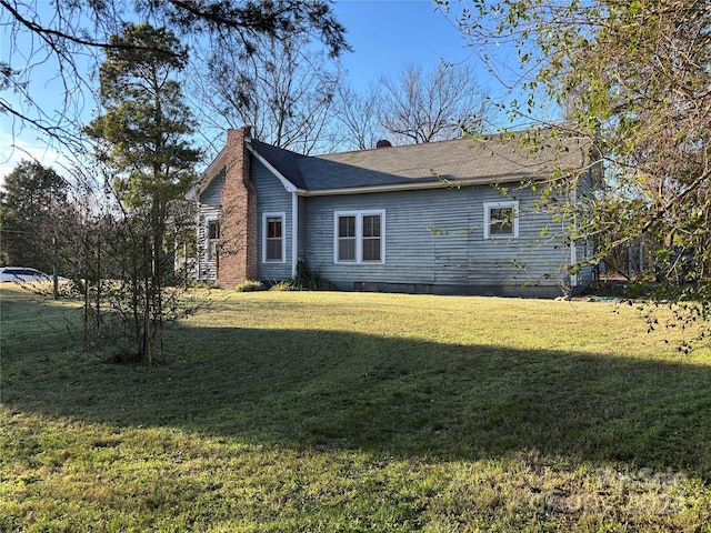 view of home's exterior with a yard