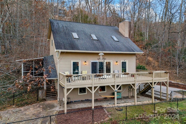 rear view of property with a deck