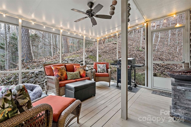 sunroom with plenty of natural light, ceiling fan, and track lighting