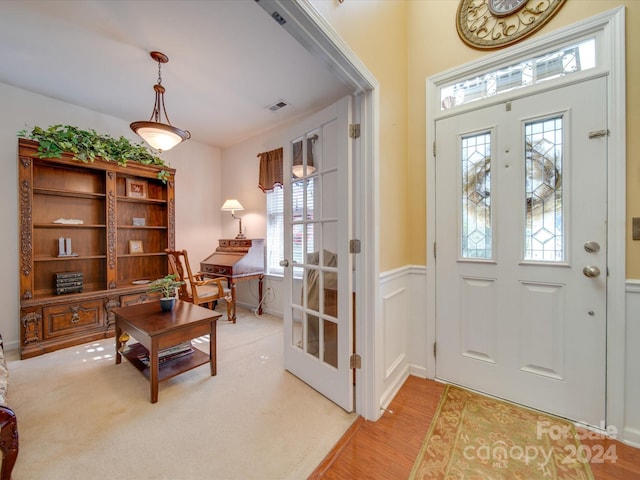 foyer featuring french doors and light hardwood / wood-style floors