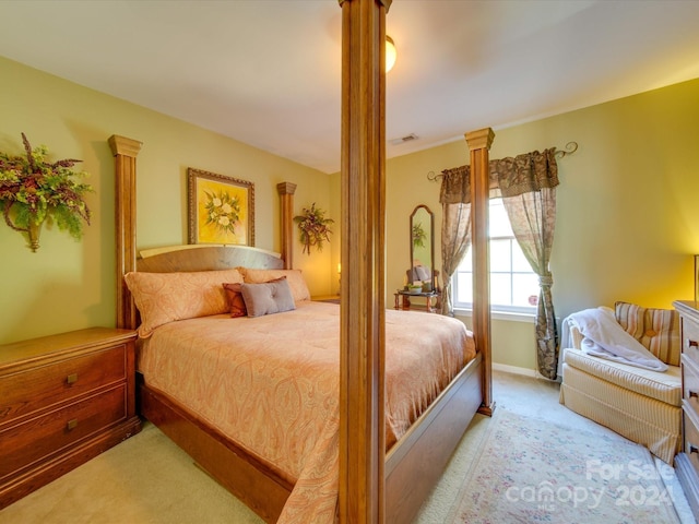 carpeted bedroom with ornate columns