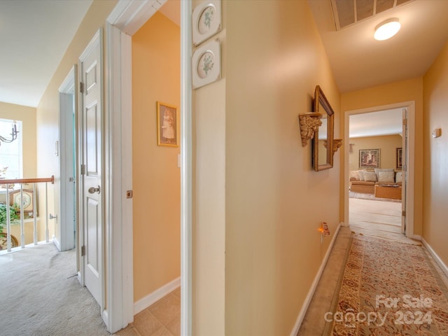 hall featuring light colored carpet