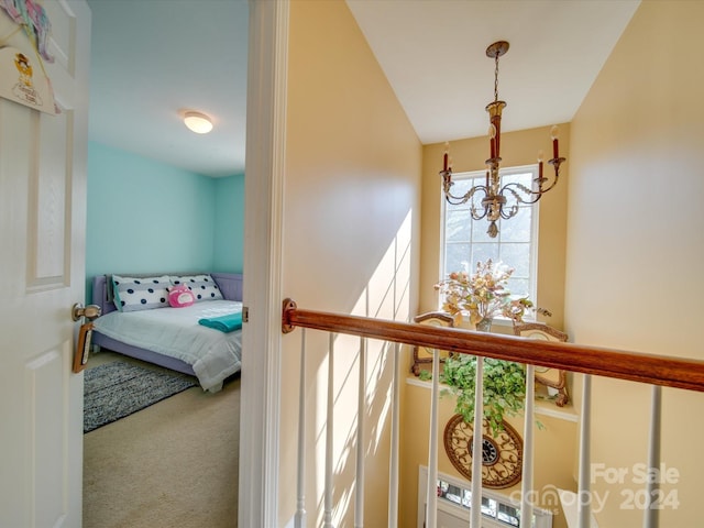 carpeted bedroom featuring a chandelier