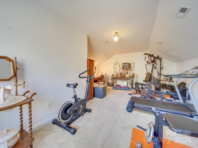 exercise area featuring carpet floors and lofted ceiling