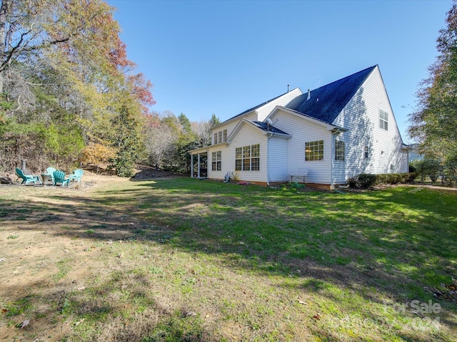 back of property featuring a lawn