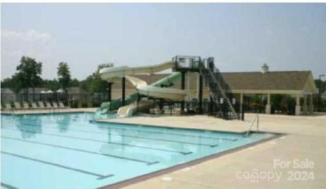 view of swimming pool with a water slide