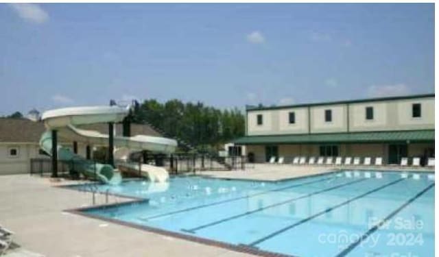 view of swimming pool featuring a water slide