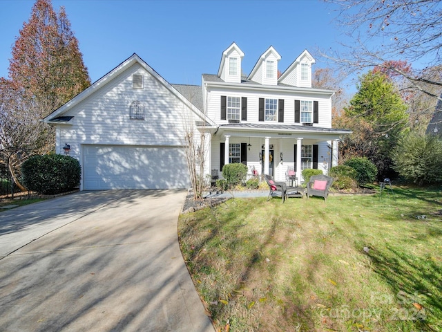 view of front of home featuring a garage, a porch, and a front yard