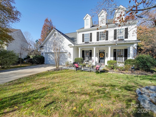 view of front of home featuring a garage, covered porch, and a front lawn