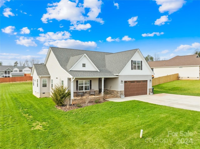 view of front of property with a garage and a front lawn