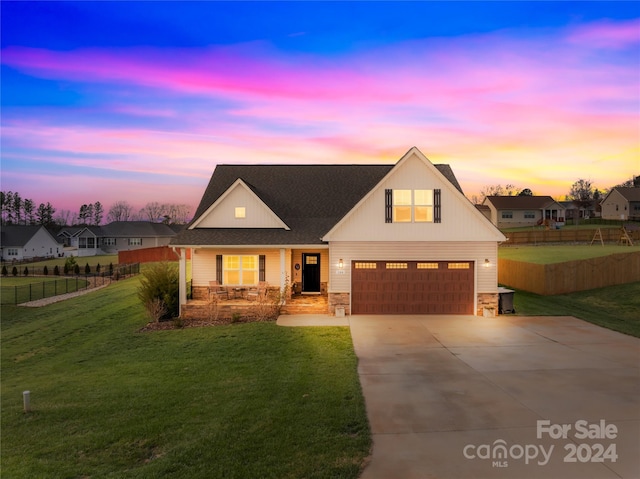 view of front of property featuring a yard and a garage