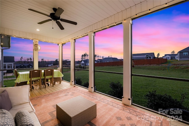 sunroom / solarium with ceiling fan and wood ceiling