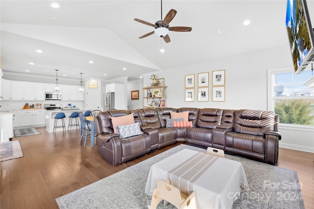 living room with wood-type flooring, ceiling fan, and lofted ceiling