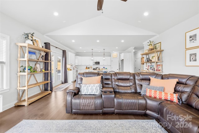 living room featuring ceiling fan, wood-type flooring, and lofted ceiling