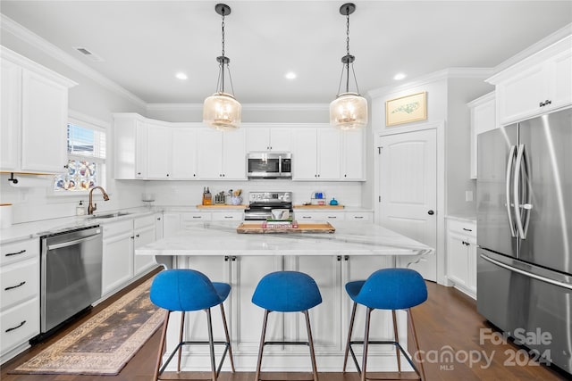 kitchen featuring white cabinetry, a kitchen island, light stone counters, and appliances with stainless steel finishes